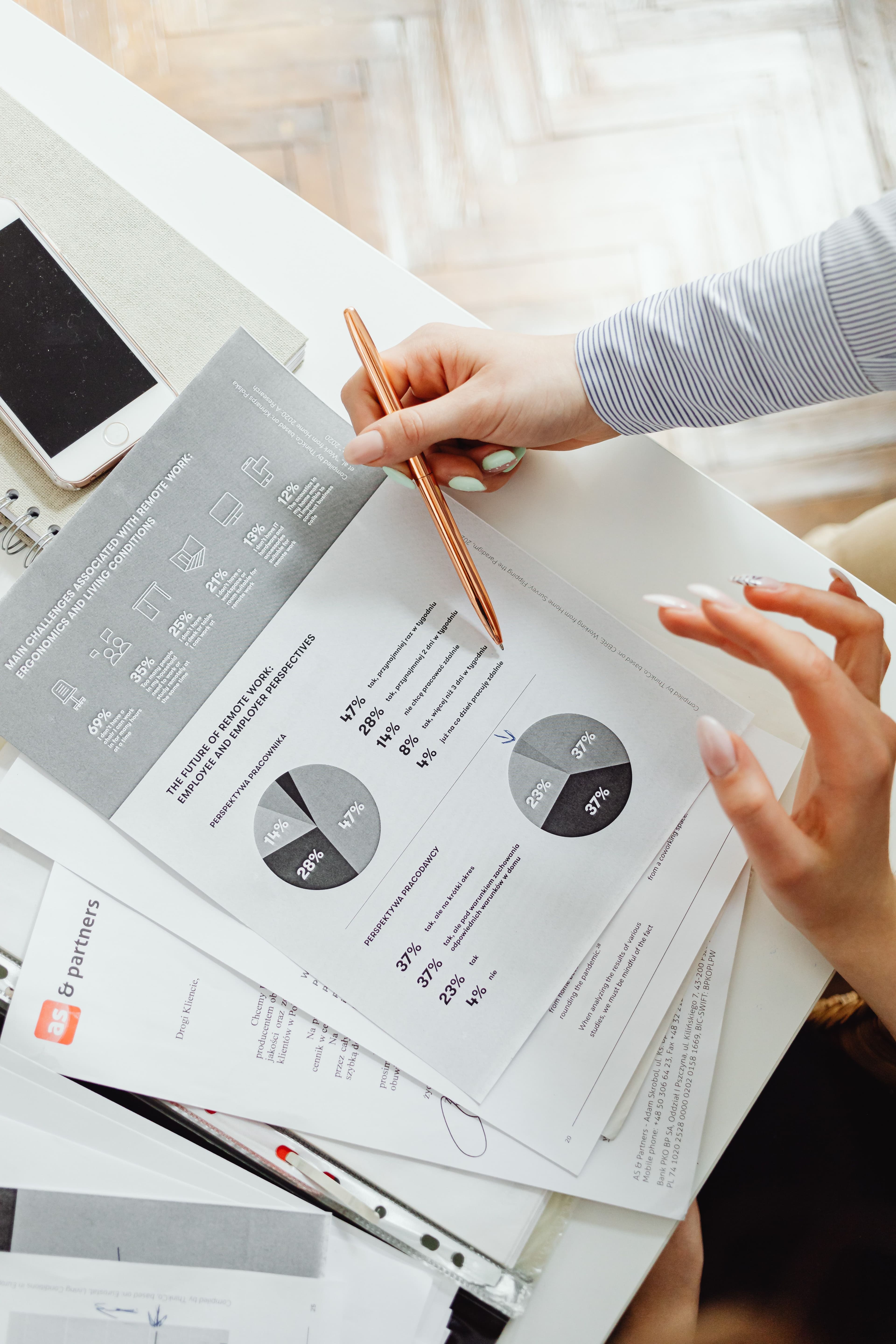 Professional reviewing financial reports and charts at a clean desk